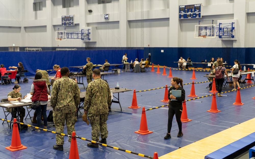 Service members and residents participate in an Emergency Evacuation Program exercise