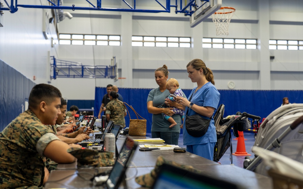 Service members and residents participate in an Emergency Evacuation Program exercise