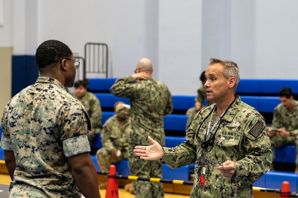 Service members and residents participate in an Emergency Evacuation Program exercise