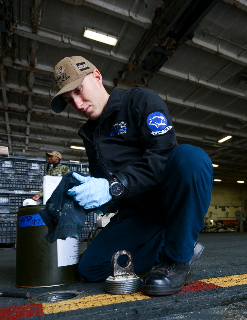 U.S. Navy Sailor Lubricates A Baxter Bolt