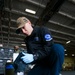 U.S. Navy Sailor Lubricates A Baxter Bolt