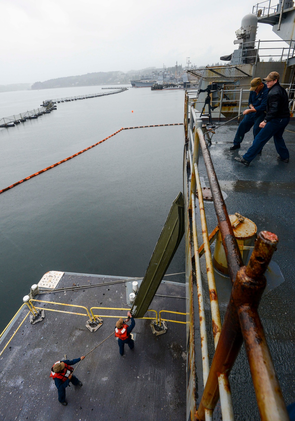 U.S. Navy Sailors Lower A Boat