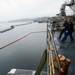 U.S. Navy Sailors Lower A Boat