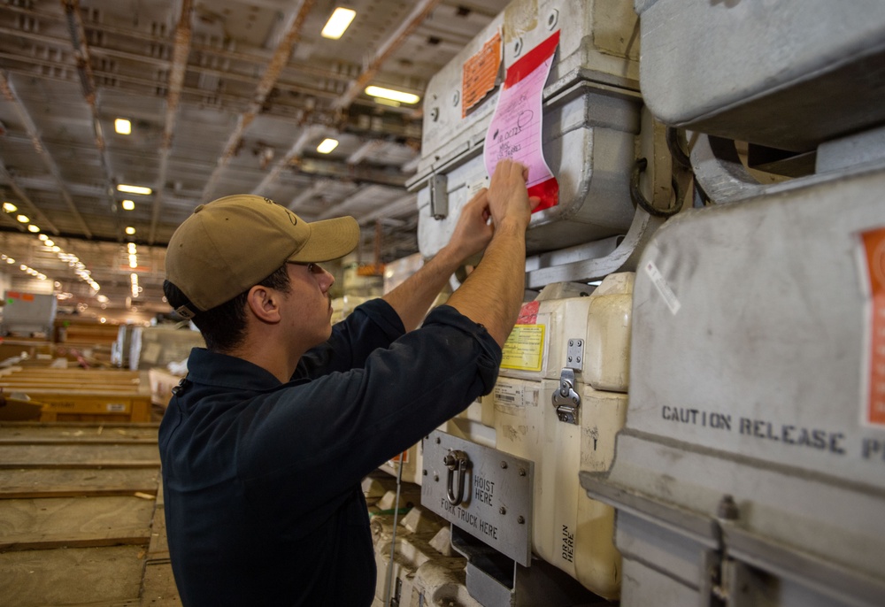 U.S. Navy Sailor Preps Material For Offload