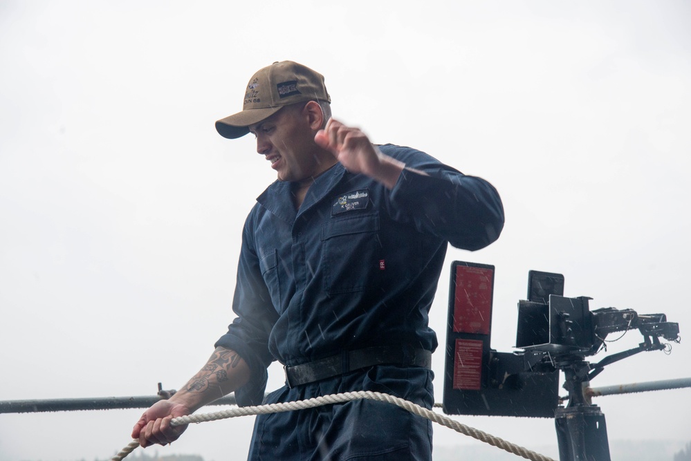 U.S. Navy Sailor Lowers Boat Off Of Ship