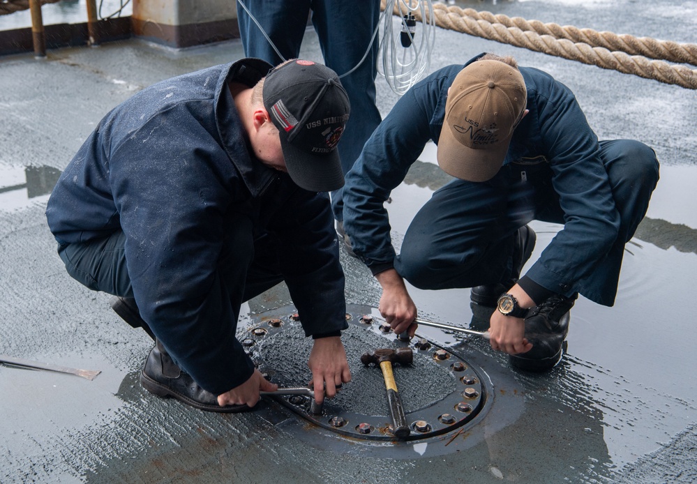 U.S. Navy Sailors Secure Hatch