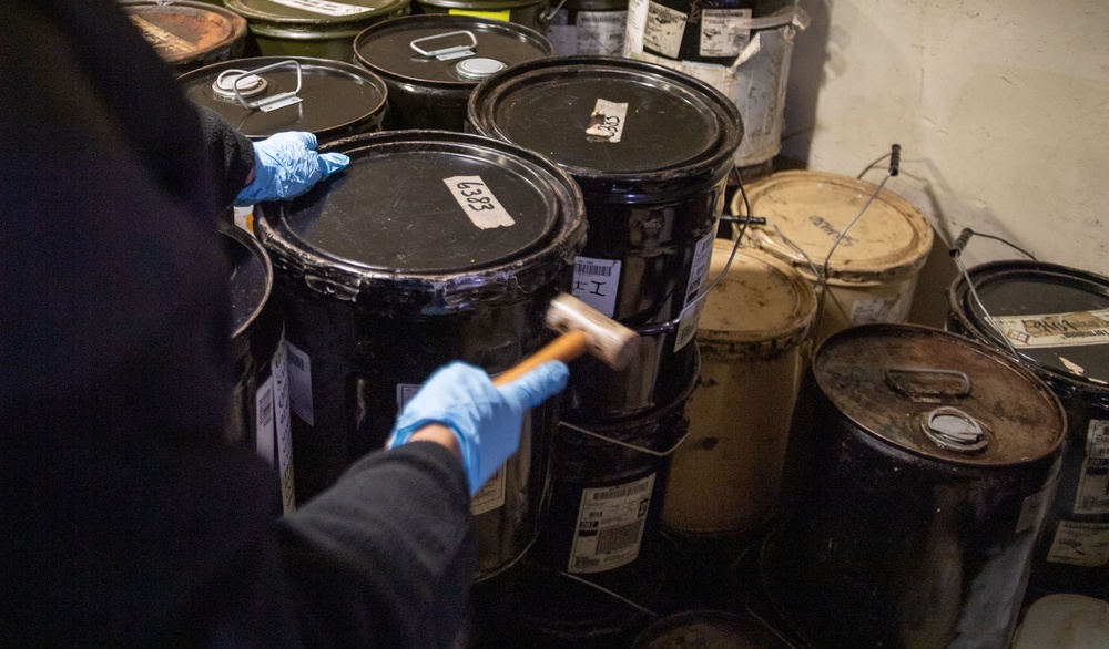 U.S. Navy Sailor Secures Grease Container