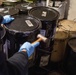 U.S. Navy Sailor Secures Grease Container