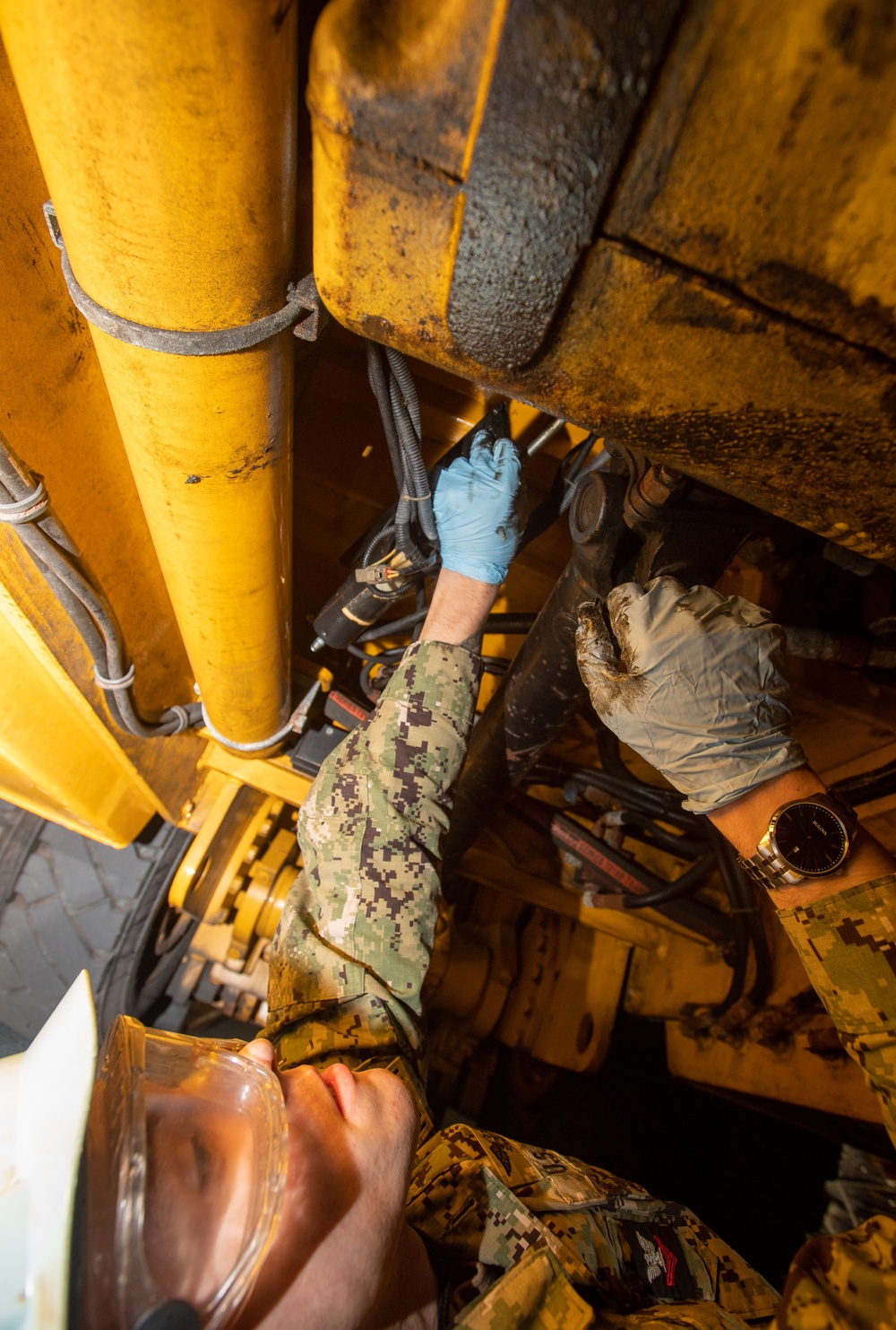 U.S. Navy Sailor Greases Axel