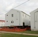 Work to build new foundations for relocated World War II-era barracks continues at Fort McCoy