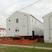 Work to build new foundations for relocated World War II-era barracks continues at Fort McCoy