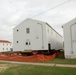 Work to build new foundations for relocated World War II-era barracks continues at Fort McCoy