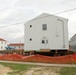 Work to build new foundations for relocated World War II-era barracks continues at Fort McCoy