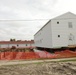 Work to build new foundations for relocated World War II-era barracks continues at Fort McCoy