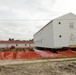 Work to build new foundations for relocated World War II-era barracks continues at Fort McCoy