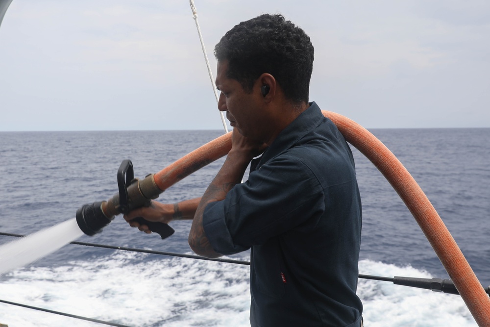 Sailors aboard the USS Rafael Peralta (DDG 115) conduct a freshwater wash down in the South China Sea