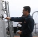 Sailors aboard the USS Rafael Peralta (DDG 115) conduct a freshwater wash down in the South China Sea