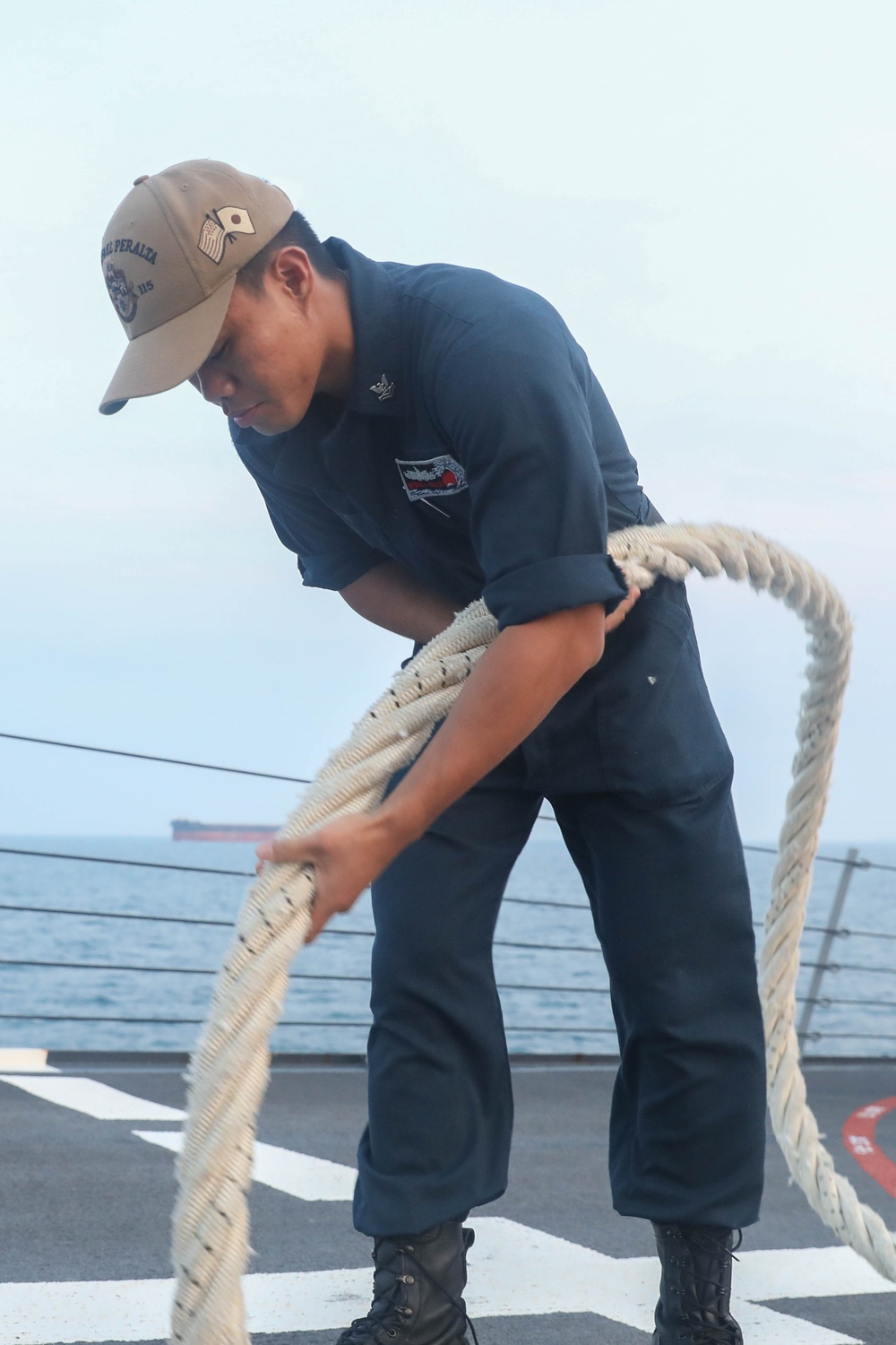 Sailors aboard the USS Rafael Peralta (DDG 115) conduct sea and anchor detail during a scheduled port visit to Singapore