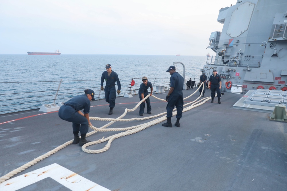 Sailors aboard the USS Rafael Peralta (DDG 115) conduct sea and anchor detail during a scheduled port visit to Singapore