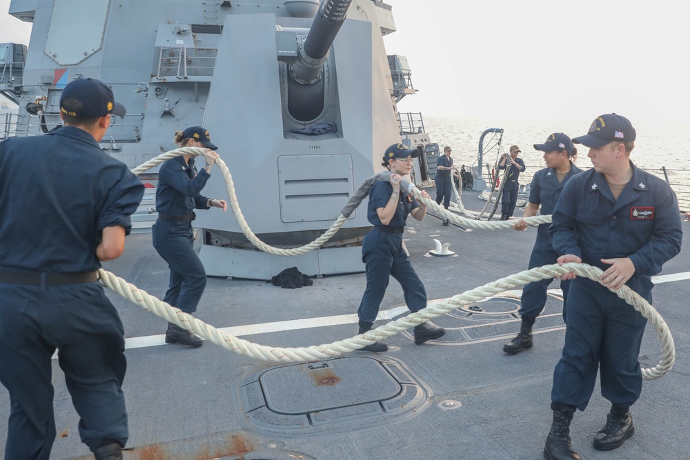 Sailors aboard the USS Rafael Peralta (DDG 115) conduct sea and anchor detail during a scheduled port visit to Singapore