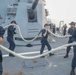 Sailors aboard the USS Rafael Peralta (DDG 115) conduct sea and anchor detail during a scheduled port visit to Singapore