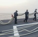 Sailors aboard the USS Rafael Peralta (DDG 115) conduct sea and anchor detail during a scheduled port visit to Singapore