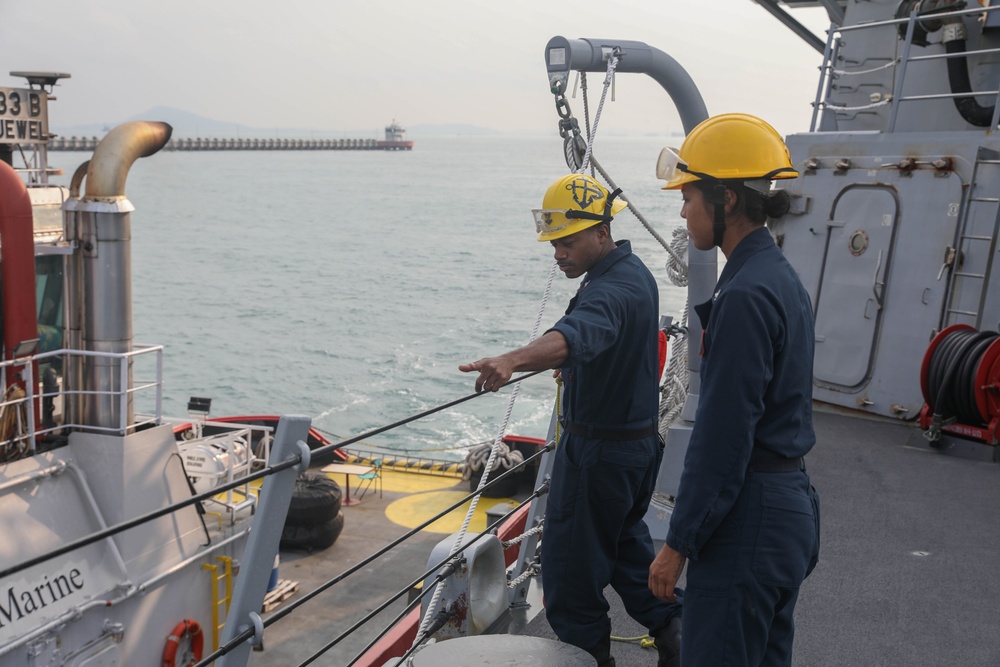 Sailors aboard the USS Rafael Peralta (DDG 115) conduct sea and anchor detail during a scheduled port visit to Singapore