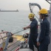 Sailors aboard the USS Rafael Peralta (DDG 115) conduct sea and anchor detail during a scheduled port visit to Singapore