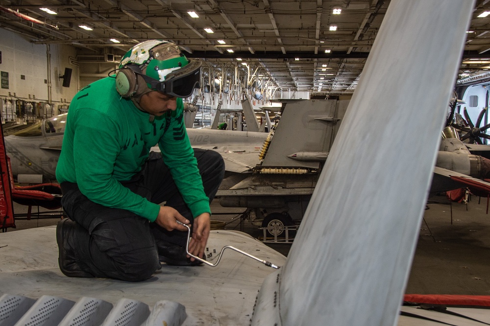 USS Ronald Reagan (CVN 76) Sailors conduct maintenance and inspections on an EA-18G Growler