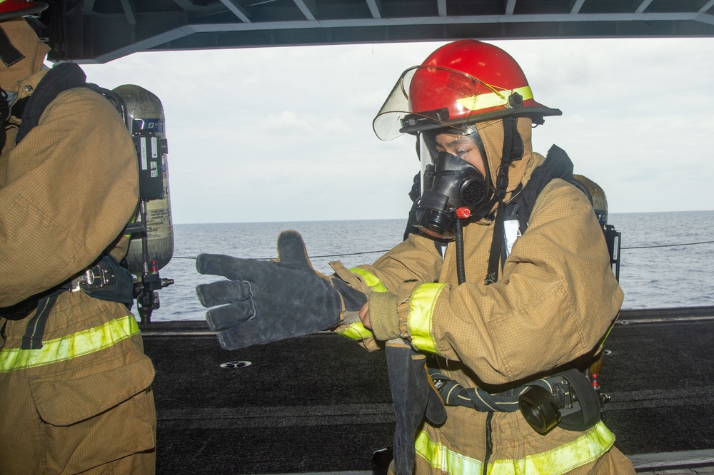 USS Ronald Reagan (CVN 76) Sailors simulate firefighting during general quarters drill
