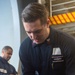 USS Ronald Reagan (CVN 76) Sailors simulate firefighting during general quarters drill