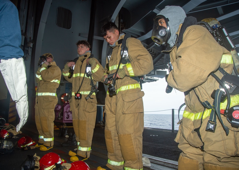 USS Ronald Reagan (CVN 76) Sailors simulate firefighting during general quarters drill