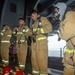 USS Ronald Reagan (CVN 76) Sailors simulate firefighting during general quarters drill