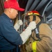 USS Ronald Reagan (CVN 76) Sailors simulate firefighting during general quarters drill