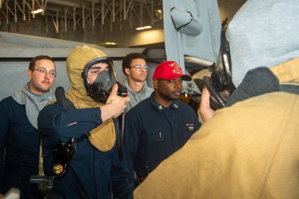 USS Ronald Reagan (CVN 76) Sailors simulate firefighting during general quarters drill