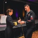 U.S. Navy Sailor presents the first slice of cake