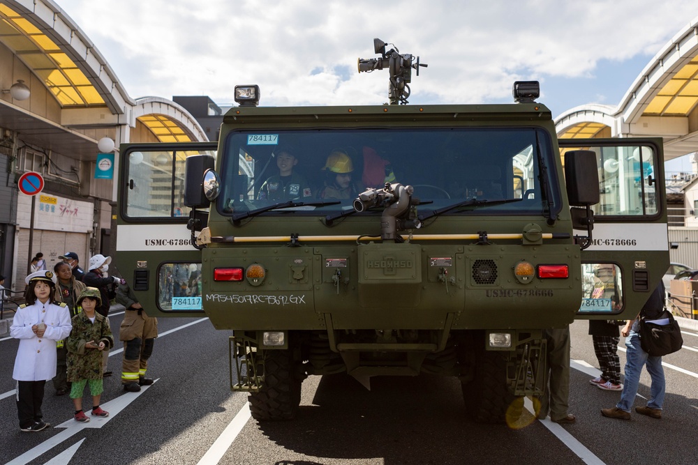 Coming Together - U.S. service members with Marine Corps Air Station Iwakuni participate in Iwakuni Matsuri Festival and Parade