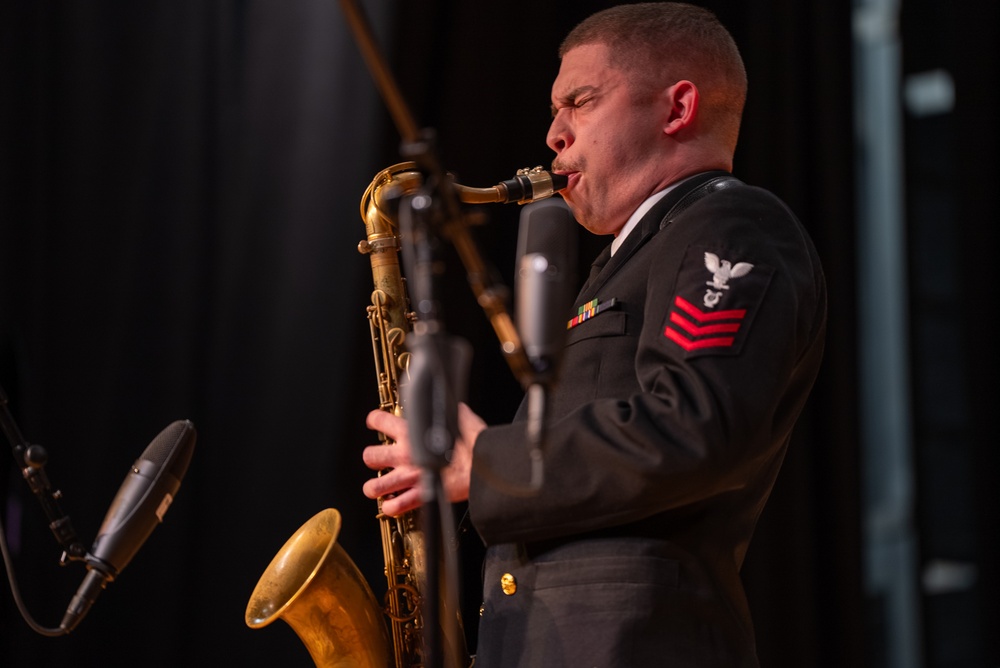 Musician 1st Class Justin Mendez performs a solo at James Benson Dudley High School