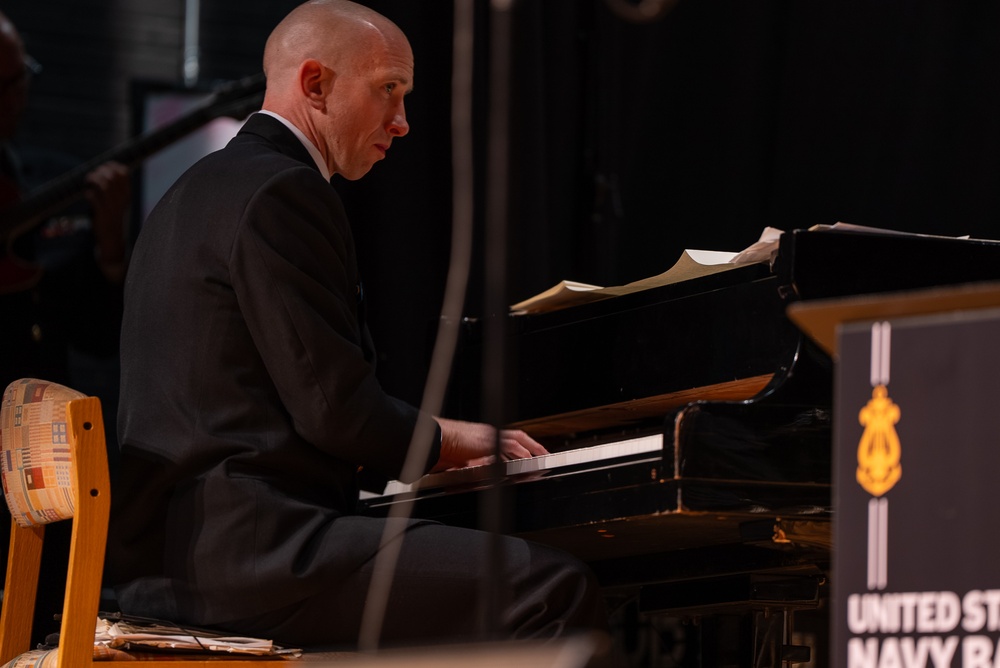 Musician 1st Class Ryan Hanseler performs a solo at James Benson Dudley High School