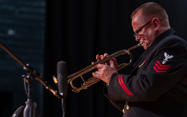 Musician 1st Class Thomas Eby performs a solo at James Benson Dudley High School