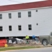 Work to build new foundations for relocated World War II-era barracks continues at Fort McCoy