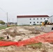 Work to build new foundations for relocated World War II-era barracks continues at Fort McCoy