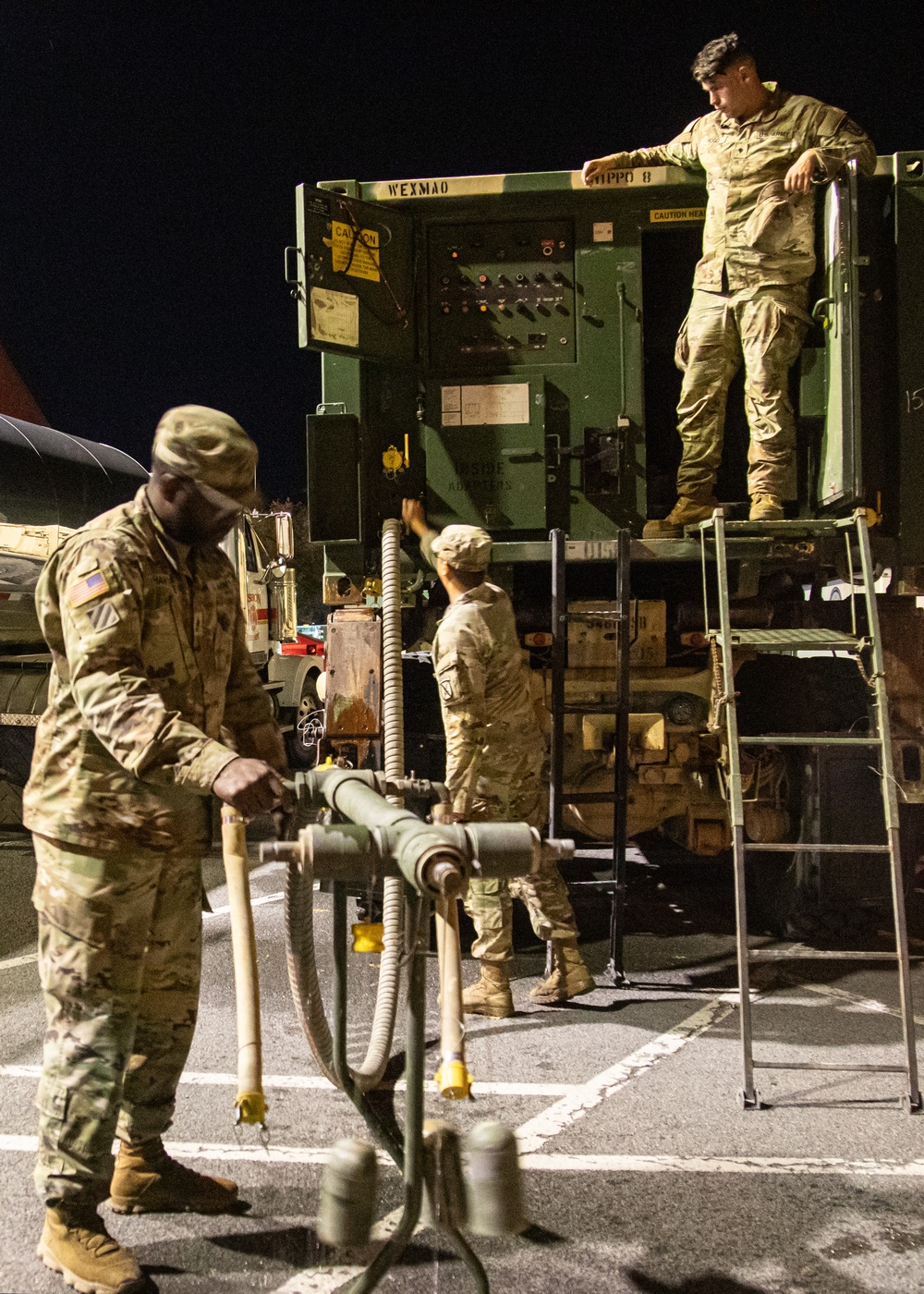 The 10th Mountain Division Sustainment Brigade help distribute water outside of the Watertown Municipal Arena to residents of Watertown, New York.