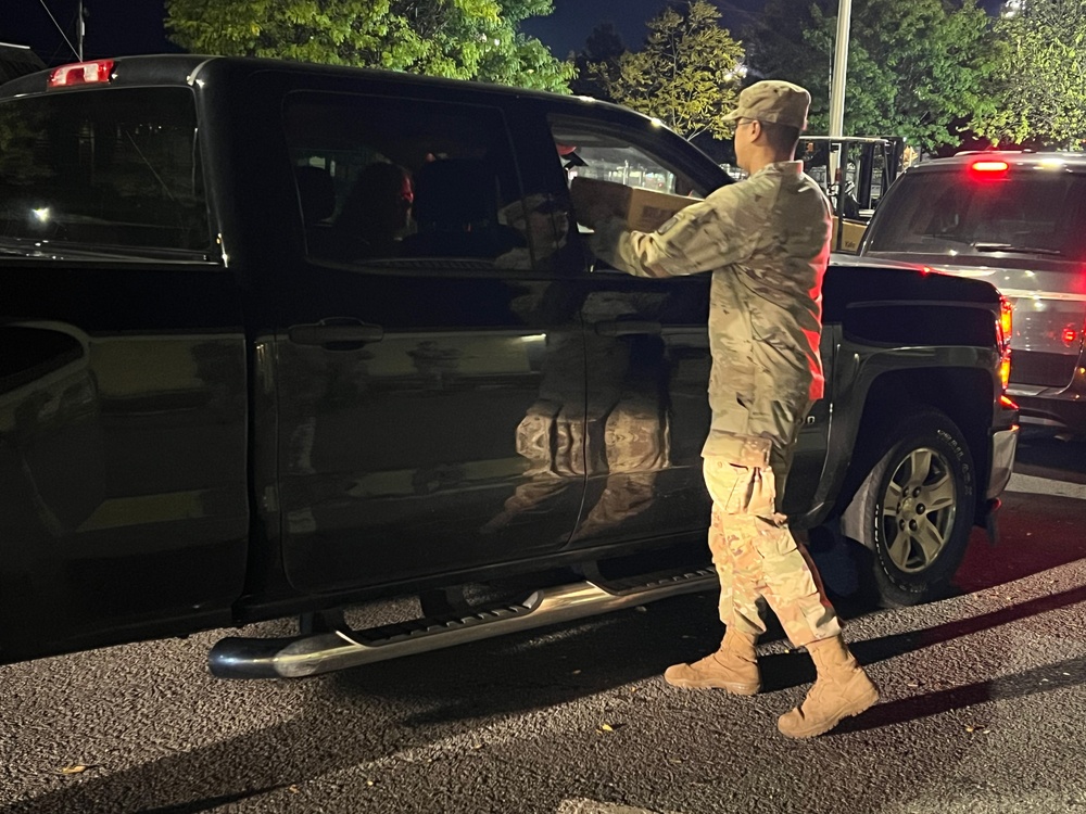 The 10th Mountain Division Sustainment Brigade help distribute water outside of the Watertown Municipal Arena to residents of Watertown, New York.