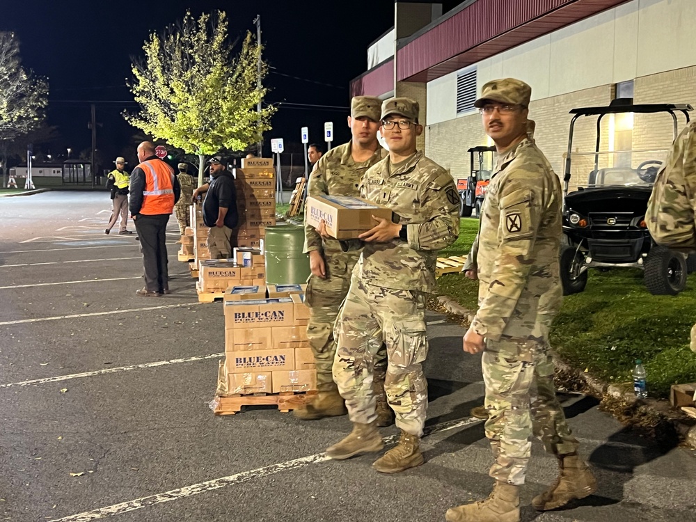 The 10th Mountain Division Sustainment Brigade help distribute water outside of the Watertown Municipal Arena to residents of Watertown, New York.