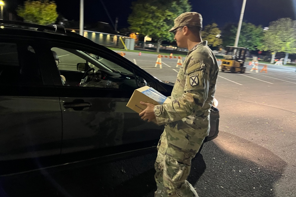 The 10th Mountain Division Sustainment Brigade help distribute water outside of the Watertown Municipal Arena to residents of Watertown, New York.