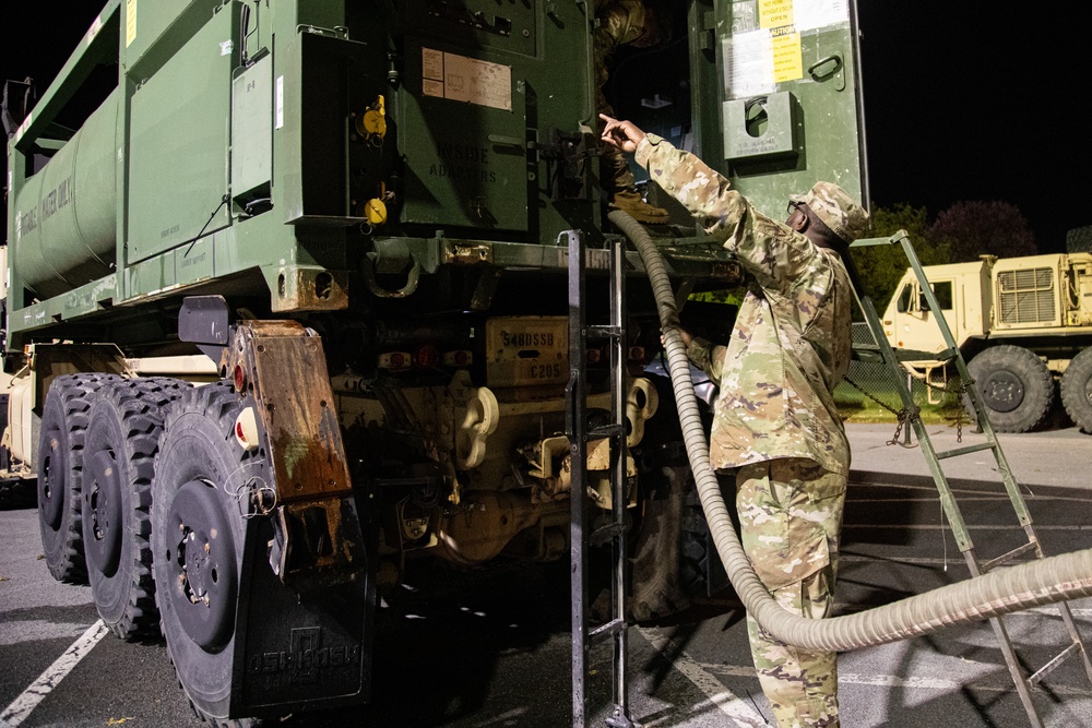 The 10th Mountain Division Sustainment Brigade help distribute water outside of the Watertown Municipal Arena to residents of Watertown, New York.