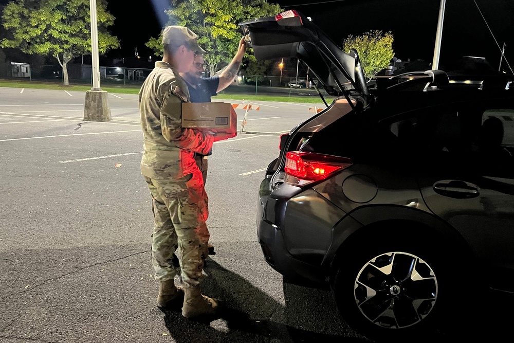 The 10th Mountain Division Sustainment Brigade help distribute water outside of the Watertown Municipal Arena to residents of Watertown, New York.