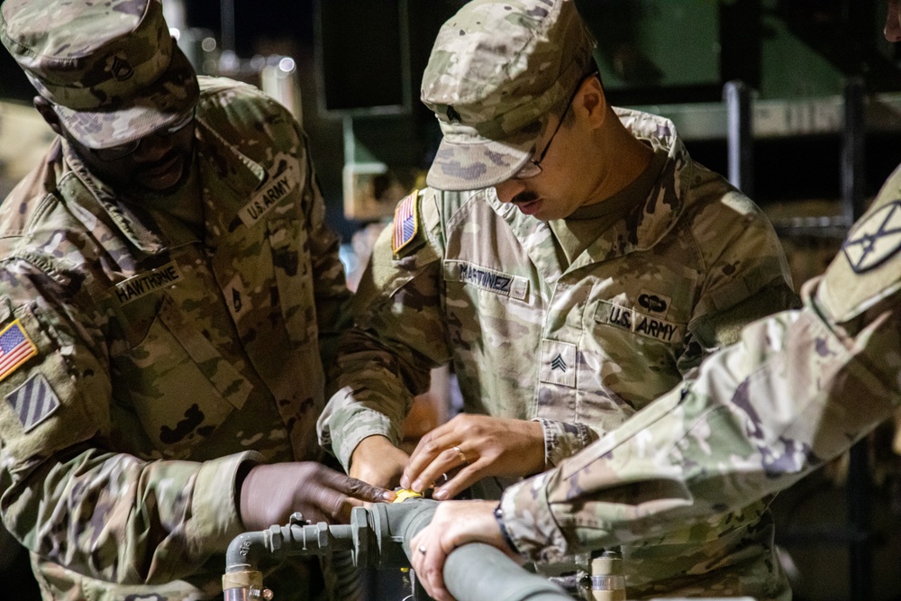 The 10th Mountain Division Sustainment Brigade help distribute water outside of the Watertown Municipal Arena to residents of Watertown, New York.