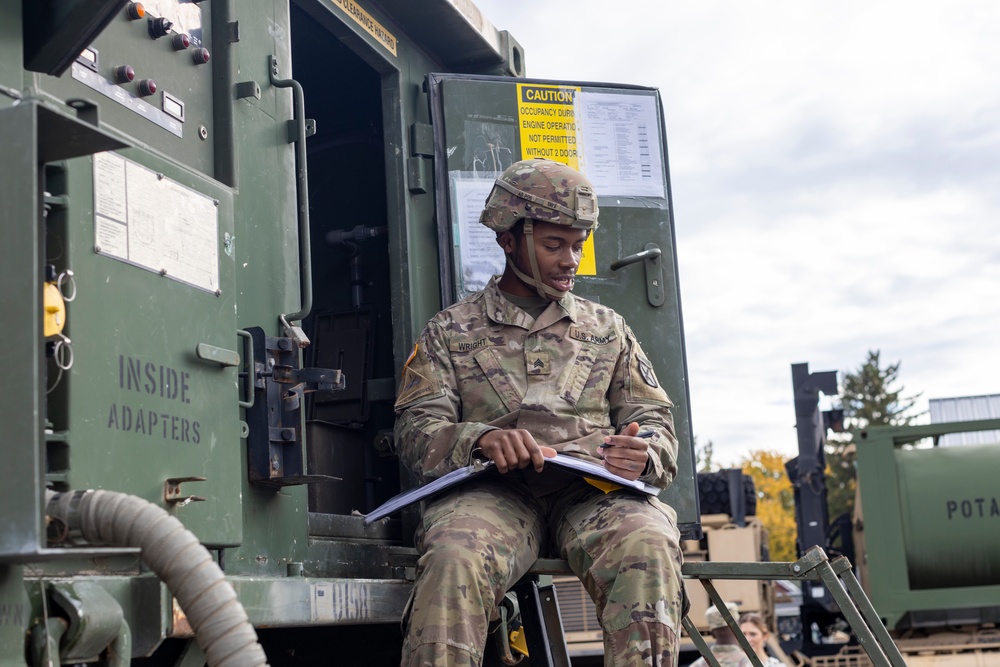 The 10th Mountain Division Sustainment Brigade help distribute water outside of the Watertown Municipal Arena to residents of Watertown, New York.